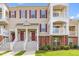 Inviting home exterior with a large porch, brick accents and green front lawn at 10530 Sablewood Dr # 112, Raleigh, NC 27617