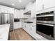 Well-equipped kitchen with stainless steel appliances and sleek white cabinetry at 10530 Sablewood Dr # 112, Raleigh, NC 27617