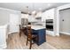 Bright kitchen with a blue island, stainless steel appliances and white cabinets at 10530 Sablewood Dr # 112, Raleigh, NC 27617