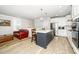 Modern kitchen featuring stainless steel appliances, white cabinets, and a blue center island at 10530 Sablewood Dr # 112, Raleigh, NC 27617