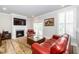 Bright living room with a fireplace, TV, and balcony access, perfect for relaxation and entertainment at 10530 Sablewood Dr # 112, Raleigh, NC 27617
