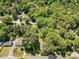 The aerial view shows a home nestled among lush trees in a neighborhood at 107 Forest Rd, Oxford, NC 27565