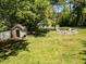 The backyard features a storage shed and a cozy fire pit surrounded by chairs at 107 Forest Rd, Oxford, NC 27565