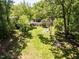 Aerial view of backyard featuring a green lawn and a charming fire pit area at 107 Forest Rd, Oxford, NC 27565