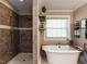 Luxurious bathroom featuring a freestanding tub, separate shower, and stylish fixtures at 107 Forest Rd, Oxford, NC 27565