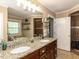 Elegant bathroom features double sinks, granite countertop, and walk-in shower with tiled walls at 107 Forest Rd, Oxford, NC 27565