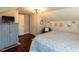 Charming bedroom featuring wood floors, soft lighting, and a classic blue and white quilt at 107 Forest Rd, Oxford, NC 27565