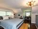 Bright bedroom with sloped ceilings, hardwood floors, and a decorative chandelier at 107 Forest Rd, Oxford, NC 27565