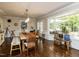Sunlit dining room with large windows, hardwood floors, and stylish decor at 107 Forest Rd, Oxford, NC 27565