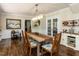 Elegant dining room with hardwood floors, wainscoting, and a modern chandelier above the dining table at 107 Forest Rd, Oxford, NC 27565