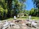 Backyard fire pit area with Adirondack chairs, ideal for outdoor gatherings and relaxing evenings at 107 Forest Rd, Oxford, NC 27565