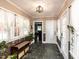 Inviting foyer with stone tile flooring, decorative wallpaper, and sheer window curtains at 107 Forest Rd, Oxford, NC 27565