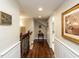 Elegant hallway with hardwood floors, wainscoting, and decorative wall art at 107 Forest Rd, Oxford, NC 27565