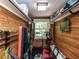 Compact home gym featuring wood-paneled walls, exercise equipment, and ample storage at 107 Forest Rd, Oxford, NC 27565