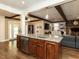 Open-concept kitchen with granite island, stainless steel dishwasher, hardwood floors, and wood beam ceiling at 107 Forest Rd, Oxford, NC 27565