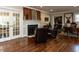 Comfortable living room featuring hardwood floors, a fireplace, and adjacent office and living spaces at 107 Forest Rd, Oxford, NC 27565