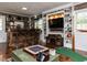 Entertaining living room area with bar, large TV, and sports-themed decor at 107 Forest Rd, Oxford, NC 27565