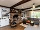 Comfortable living room featuring a brick fireplace, built-in bookshelves, and a large window at 107 Forest Rd, Oxford, NC 27565