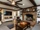 Cozy living room showcasing brick fireplace, ceiling fan, and comfortable furniture at 107 Forest Rd, Oxford, NC 27565