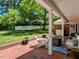 Covered patio featuring a brick floor, white columns, comfortable seating, and a view of the backyard at 107 Forest Rd, Oxford, NC 27565