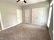 A bedroom with neutral paint and carpet features white trim and multiple closets at 113 Conner Dr # 103, Chapel Hill, NC 27514