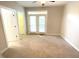 Bedroom featuring neutral carpet, paint, and access to a private outdoor balcony at 113 Conner Dr # 103, Chapel Hill, NC 27514