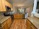 Spacious kitchen featuring stainless steel appliances, granite counters, and wood floors at 113 Conner Dr # 103, Chapel Hill, NC 27514
