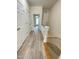 Hallway with wood-look flooring and a staircase, connecting different levels of the home for easy navigation at 113 Conner Dv # 106, Chapel Hill, NC 27514