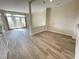 Spacious living room featuring light wood floors and access to a balcony through elegant French doors at 113 Conner Dv # 106, Chapel Hill, NC 27514