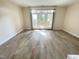 Bright living room featuring light wood floors and French doors that open to an outdoor space at 113 Conner Dv # 106, Chapel Hill, NC 27514