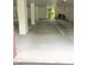 Garage with a red brick wall and a parking spot with a 3-wheeled bike in it at 113 Conner Dv # 106, Chapel Hill, NC 27514