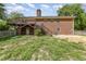 The backyard features a brick house, a deck, and a door that leads to the backyard at 1303 Cherry Dr, Burlington, NC 27215