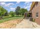 This backyard features a brick house, wooden deck, and a mix of grass and dirt at 1303 Cherry Dr, Burlington, NC 27215