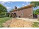 This backyard showcases a brick house, wooden deck, and an empty lot ready to be built on at 1303 Cherry Dr, Burlington, NC 27215