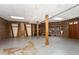 Finished basement with brick fireplace, exposed beams, and wooden details at 1303 Cherry Dr, Burlington, NC 27215