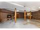The partially finished basement has a brick fireplace, a wooden door, and a utility sink at 1303 Cherry Dr, Burlington, NC 27215