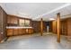 The basement features a brick accent wall with vintage wooden cabinets and a utility sink at 1303 Cherry Dr, Burlington, NC 27215