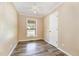 Bedroom with hardwood floors, neutral walls, window, and ceiling fan at 1303 Cherry Dr, Burlington, NC 27215