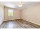 Cozy bedroom featuring a ceiling fan, window, and wood-look flooring at 1303 Cherry Dr, Burlington, NC 27215