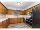 Traditional kitchen featuring wood cabinetry, stainless steel appliances, and laminate countertops at 1303 Cherry Dr, Burlington, NC 27215