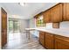 Bright eat-in kitchen with warm wood cabinets, hardwood floors, and sliding doors to the deck at 1303 Cherry Dr, Burlington, NC 27215