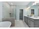 Modern bathroom featuring a large shower, soaking tub, double vanity, and sleek fixtures at 137 Cultivator Ct, Angier, NC 27501