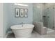 Elegant bathroom featuring a freestanding tub, a glass-enclosed shower, and stylish tile work at 137 Cultivator Ct, Angier, NC 27501