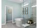 Bright bathroom featuring a soaking tub, a glass-enclosed shower, and modern design at 137 Cultivator Ct, Angier, NC 27501