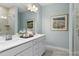 Modern bathroom featuring double sinks, white cabinets, quartz counters, and tiled shower at 137 Cultivator Ct, Angier, NC 27501