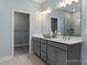Well-lit bathroom with double vanity, ample storage, and a view of a spacious walk-in closet at 137 Cultivator Ct, Angier, NC 27501