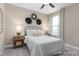 Cozy bedroom with a wrought iron bed frame, decorative wreaths, and soft, inviting colors at 137 Cultivator Ct, Angier, NC 27501