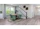 Cozy dining area with a round table, comfortable chairs, and a view of the staircase at 137 Cultivator Ct, Angier, NC 27501