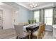 Open-concept dining room featuring modern furnishings and abundant natural light from large windows at 137 Cultivator Ct, Angier, NC 27501