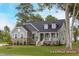 Charming single-story home featuring a stone facade, dormer windows, and inviting front porch at 137 Cultivator Ct, Angier, NC 27501